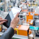 Executive Working on Tablet in Warehouse